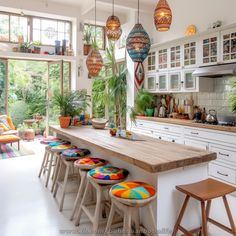 a kitchen filled with lots of counter top space next to an open floor plan area