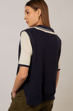 Get your preppy look on point with our navy and ivory varsity sweater vest. This lightweight yet cosy knitted vest is perfect to layer over a blue or ivory blouse. Its classic V-neck and cable-knit texture give a preppy vibe while the side slits serve as an original detail. This vegan-friendly knit will keep you warm while looking sharp. - Navy and ivory varsity vest - Cable-knit - Vegan-friendly knitwear Argyle Sweater Vest, Ivory Blouse, Varsity Sweater, Fitted Jumper, Black Herringbone, London Free, Turtle Neck Jumper, Knitted Vest, Preppy Look