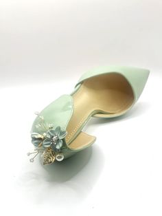 a pair of green shoes with flowers on them