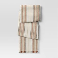 an orange and white striped scarf hanging on a wall