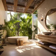 a bathroom with a large bathtub next to a sink and trees in the background