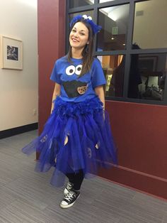 a girl in a blue shirt and skirt