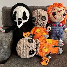 three crocheted dolls sitting next to each other on a couch with a skeleton