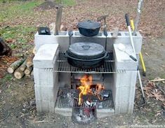 an outdoor grill with pots and pans on it