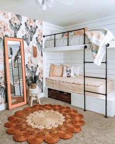 a bedroom with a bunk bed, mirror and rug