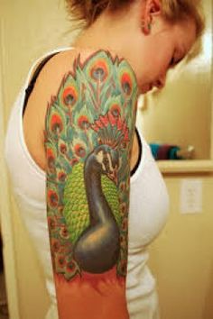 a woman with a peacock tattoo on her arm