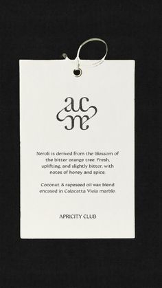 an acme sign hanging on a black wall next to a keychain with the words acme written below it