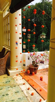 an outdoor area with orange flowers hanging from the ceiling