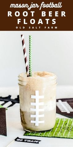 a mason jar filled with root beer floats and two striped straws on the table