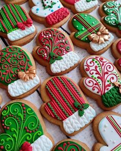 decorated christmas cookies are displayed on a table