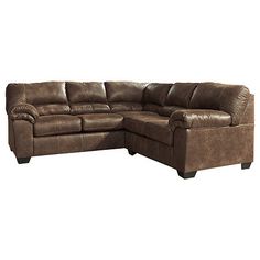 a brown leather sectional sofa sitting on top of a white floor