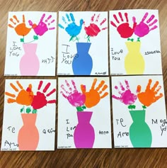 four handprints in different colors are displayed on a table with the words i love you