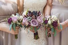 the bridesmaids are holding their bouquets in their hands