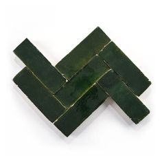 green tiles arranged in the shape of an x on a white background with room for text