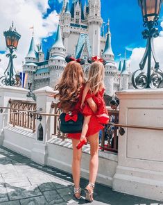 two girls in front of the castle at disney world