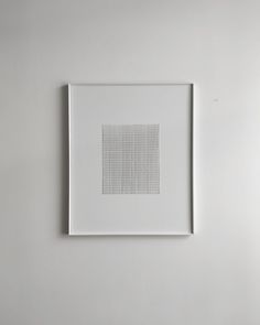 a white framed artwork hanging on the wall