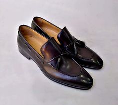 Buy TucciPolo Mens 2020 Black Handcrafted Tassel Italian Calfskin Luxury Loafers. TucciPolo shoes are handcrafted by the best shoe makers with guaranteed quality and comfort. Unique in style and exclusively designed for Men who can dress. Shop now Black hand-painted and hand polished leather upperFinest Italian calfskinTwisted Leather Tassels and leather insole sole and outsole This is a made-to-order product. Each pair will be made upon receipt of order and shipped in approximately 15 days. Bec Luxury Loafers, Black Hand, Leather Tassel, Nice Shoes, Step Up, Classic Black, Calf Skin, Black Color, Tassels