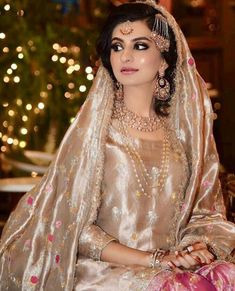 a woman in a bridal gown sitting down