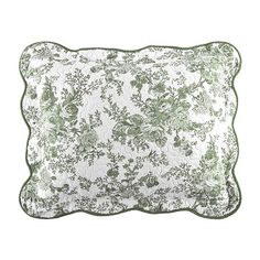 a green and white pillow with flowers on it's side, against a white background