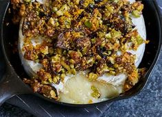 a skillet filled with pudding and toppings on top of a blue table cloth