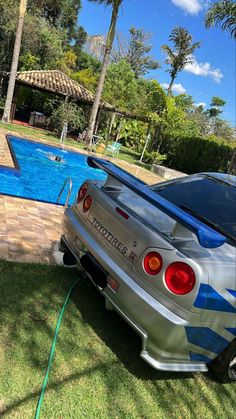 a silver car parked next to a swimming pool