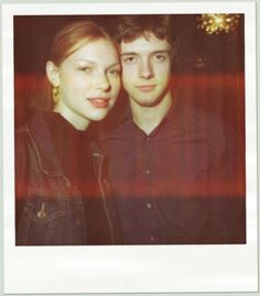 a young man and woman posing for a photo