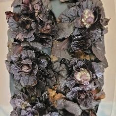 an arrangement of dried flowers in a vase