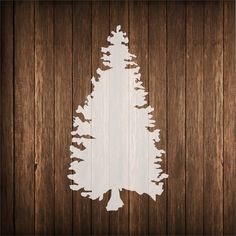 a wooden wall with a white tree cut out on it