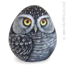 an owl figurine sitting on top of a rock