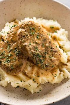 a bowl filled with mashed potatoes covered in gravy