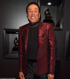 a man in a red jacket and black shirt