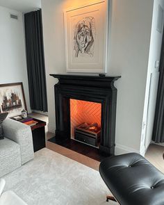 a living room with a fire place in the center and a couch on the other side