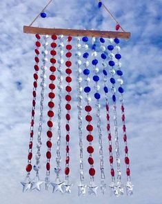 an american flag wind chime hanging in the sky with red, white and blue beads