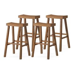 three wooden stools sitting next to each other