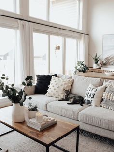 a living room filled with lots of furniture and decor on top of a wooden table