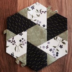 a hexagonal patchwork piece on top of a wooden table