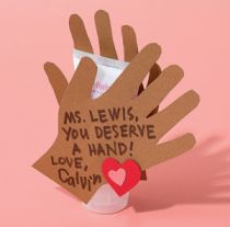 a hand holding a paper cup with a message on it that says ms lewis, you deserves a hand