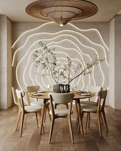 a dining room table with chairs and a vase filled with flowers on top of it