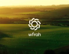 the wfrah logo is shown on top of a green field with sheep grazing in the distance