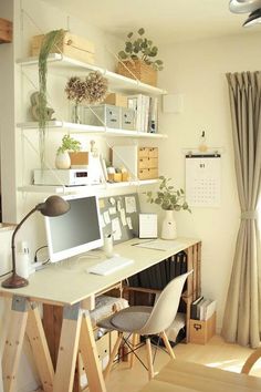 a room with a desk, chair and bookshelf filled with plants in it