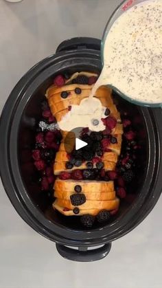 a crock pot filled with fruit and yogurt next to a bowl of cereal