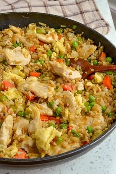 a pan filled with chicken and rice on top of a table