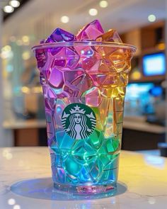 a starbucks cup filled with lots of colorful candies