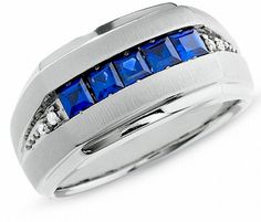 Retail Price: $650.00 Glowing vibrantly across the top, five square lab-created sapphires radiate a bright blue hue from their invisible-like setting. Brightening the shank, prong-set diamond accents glisten. A pristine and polished look just for him, this "J" back ring is set in cool, shiny 10K white gold. "J" back rings feature a closed off finish around the underside of the shank for smooth comfort. We can also use green or red princess cut stone colors if requested. We offer free ring sizing Mens Sapphire Ring, Blue Sapphire Diamond Ring, Blue Sapphire Diamond, Sapphire Diamond Ring, Blue Sapphire Rings, Sapphire Stone, Men's Ring, Size 10 Rings, Men's Rings