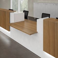 an empty office with wooden desks and chairs