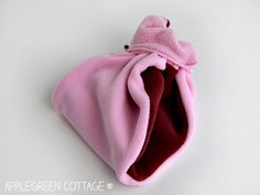 a pink and red purse sitting on top of a white table