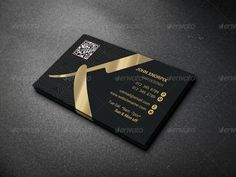 a black and gold business card with a golden ribbon on the front, and a qr code in the back