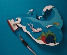 an artistically designed paper cut out of the shape of a wave with dolphins and corals on it