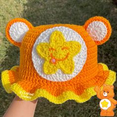 a crocheted teddy bear hat on someone's hand