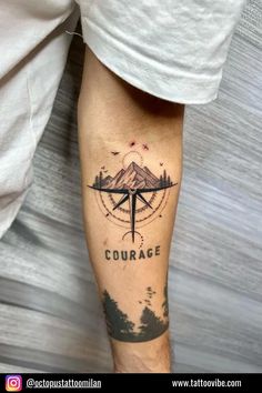 a man with a compass tattoo on his leg that reads,'courage'and the mountains